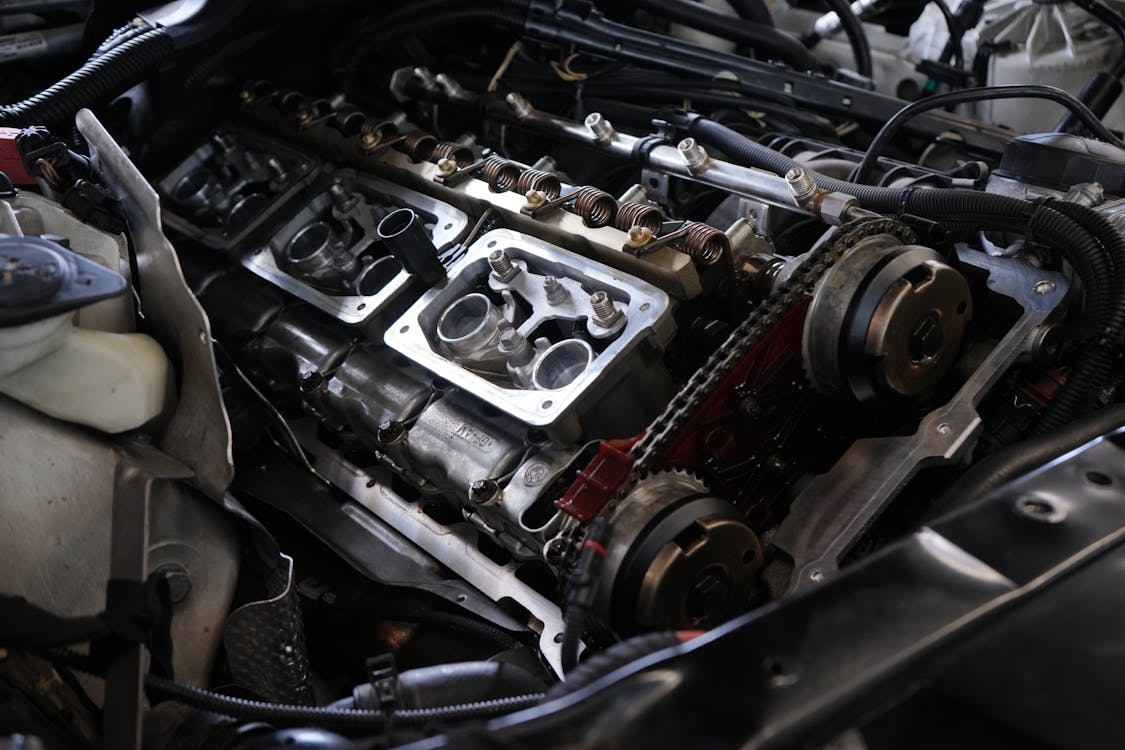 Close-up of a car engine showcasing various intricate parts and components in detail.